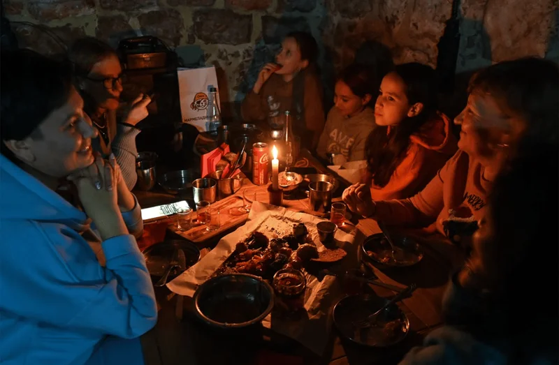 family gathered around a table during a power outage