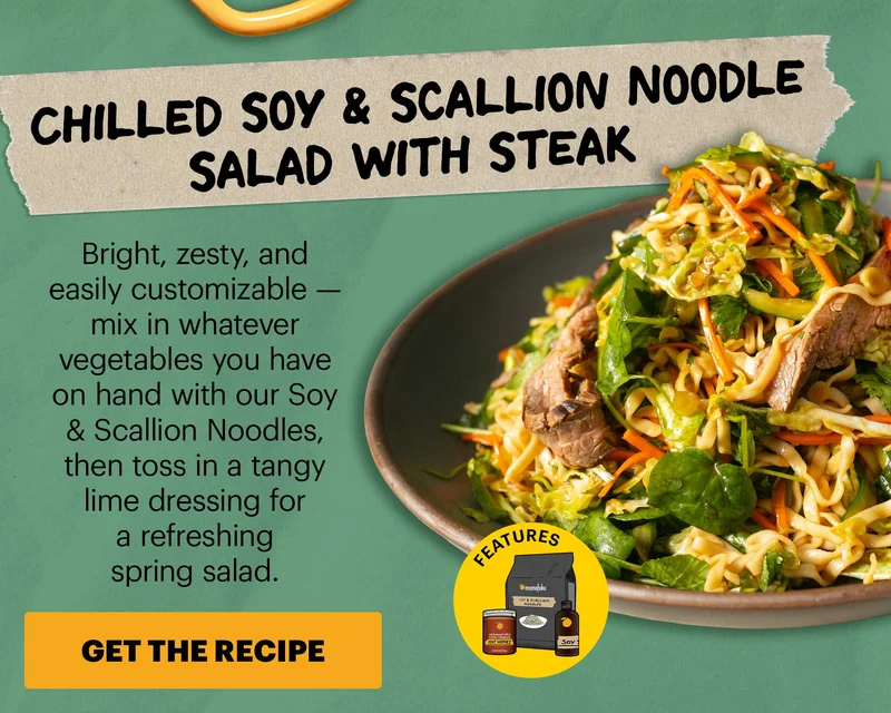 Header: Chilled Soy & Scallion Noodle Salad with Steak  Sub-header: Bright, zesty, and easily customizable — mix in whatever vegetables you have on hand with our Soy & Scallion Noodles, then toss in a tangy lime dressing for a refreshing spring salad.  CTA: GET THE RECIPE. Features Momofuku Chili Crunch Hot Honey, Soy & Scallion Noodles, Soy Sauce