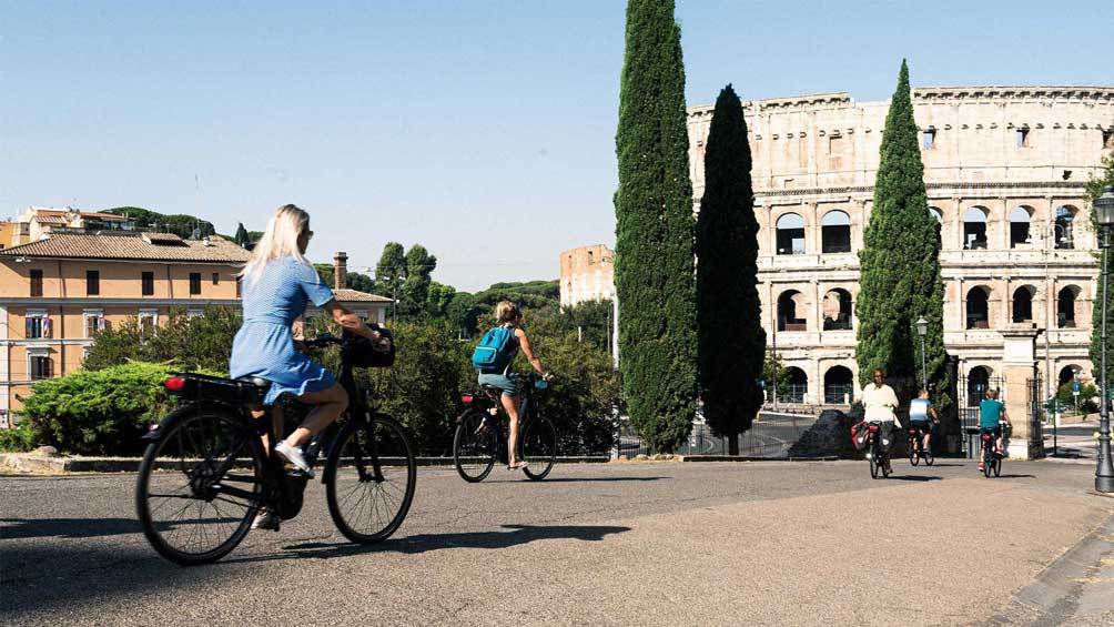 Image description: Biking past the Colosseum, in Rome.