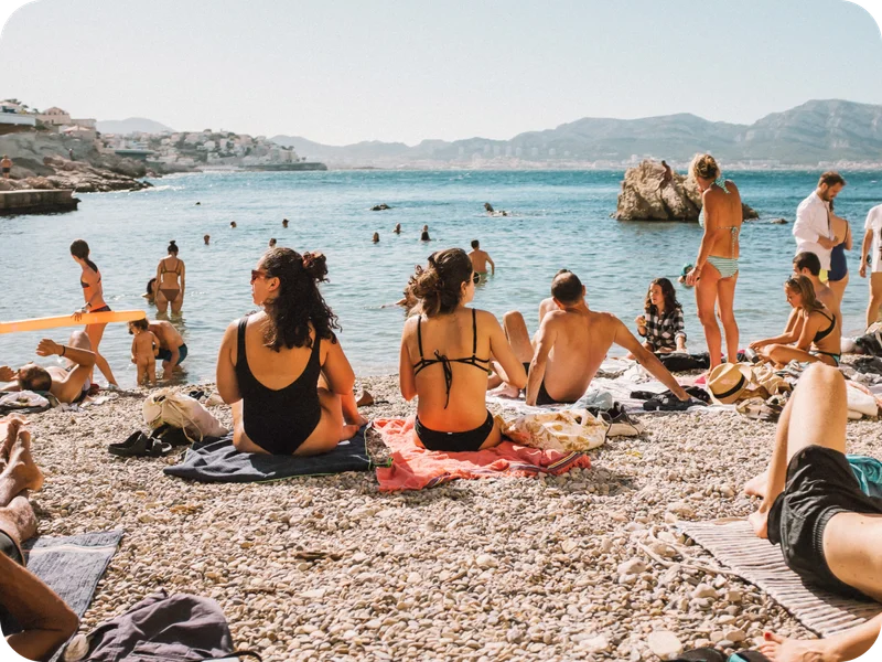 Sunbathers on a rocky beach in Marseille, France