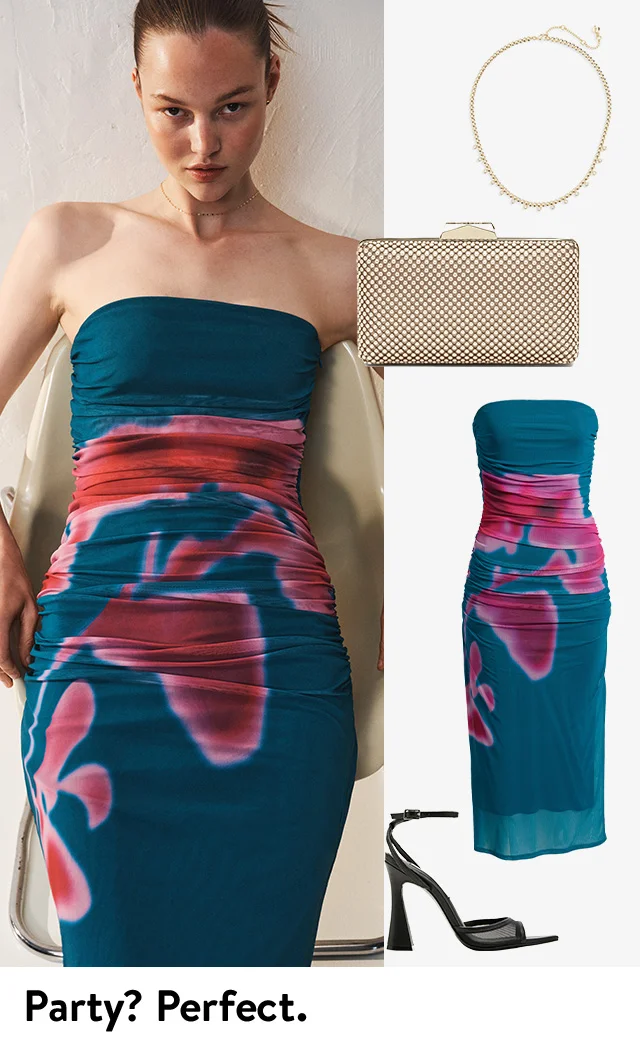 A woman wearing a strapless ruched dress with an abstract print; the dress, plus heels, a necklace and a clutch.