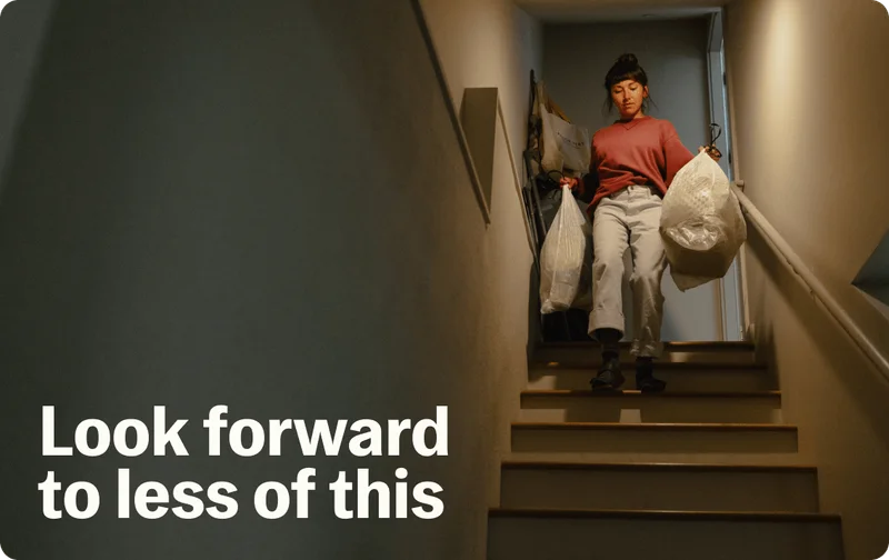 Woman taking trash bag to the curb