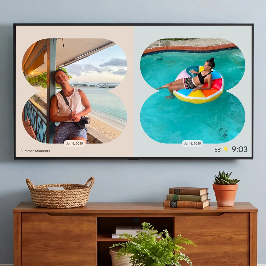 Wall-mounted TV displaying photos above a wooden console table with plants and decor.
