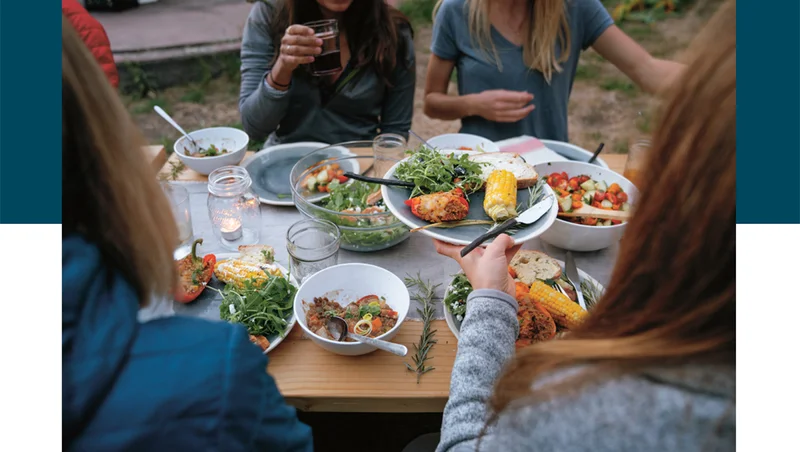 People sitting at a table sharing food.