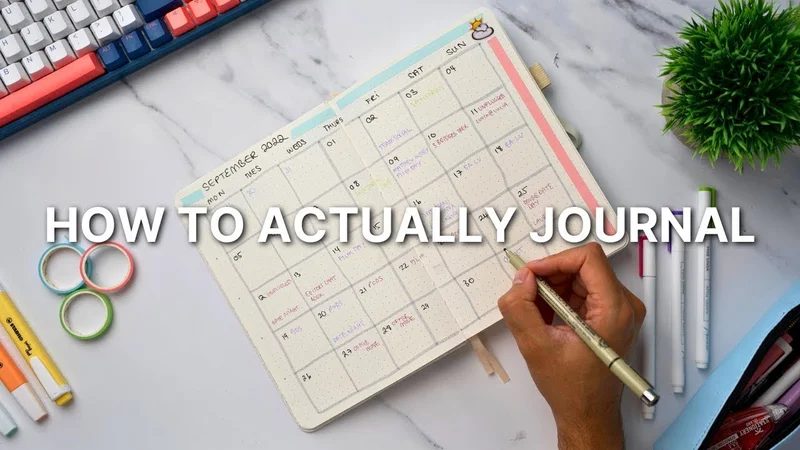 A planner on a marble surface with a hand holding a pen and filling in the schedule.