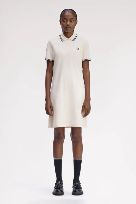 Female model wearing a Fred Perry Twin Tipped Fred Perry Dress in Silky Peach / Dark Petrol
