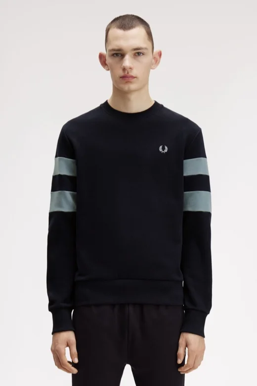Male model wearing a Fred Perry Peached Tipped Sleeve Sweatshirt in Navy