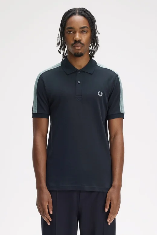 Male model wearing a Fred Perry Mesh Taped Polo in Navy