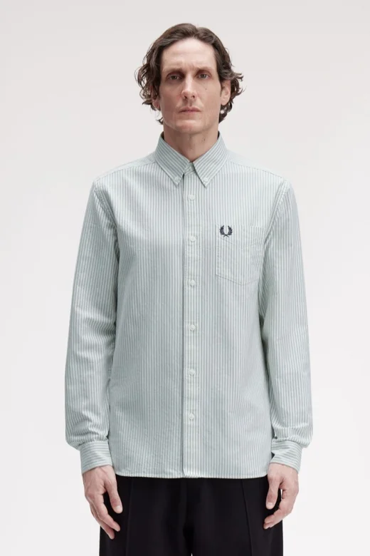 Male model wearing a Fred Perry Oxford Stripe Shirt in Bay Leaf / Snow White