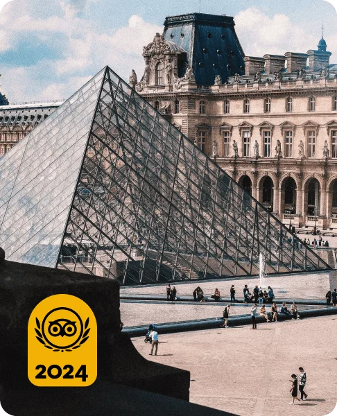 Image Description: Travelers relaxing near the iconic Louvre Pyramid in Paris