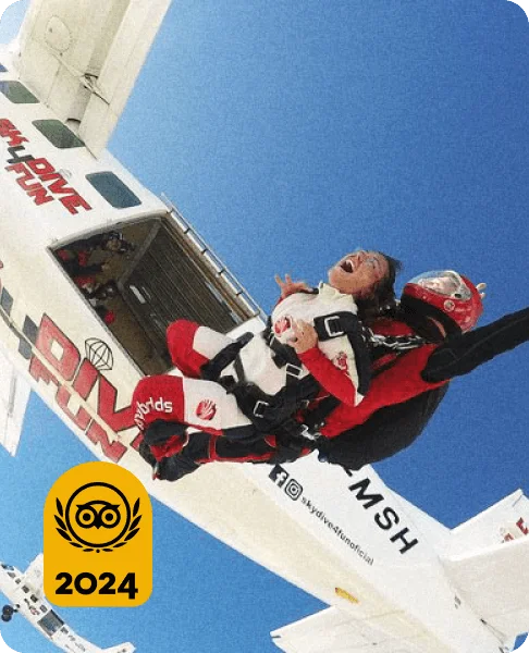 Image Description: Traveler jumping out of a plane with her tandem skydiving instructor