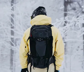 Snowboarder wearing a Burton [ak] Backpack and Jacket