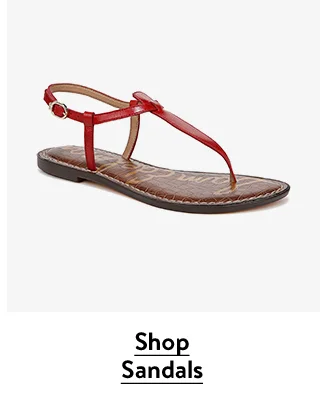 A pair of red T-strap sandals.
