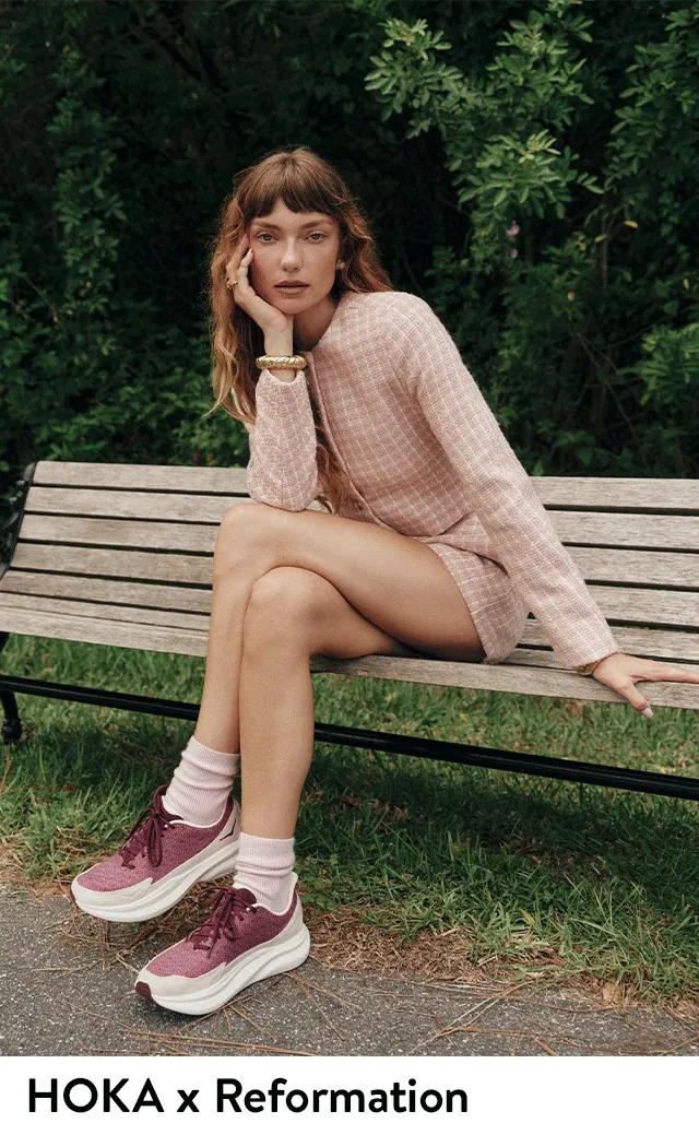 Woman wearing HOKA x Reformation sneakers.