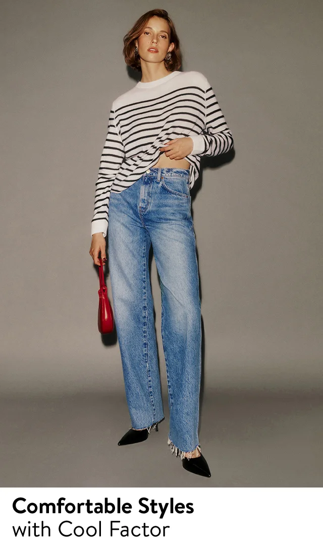 A woman wearing a striped top with blue jeans.