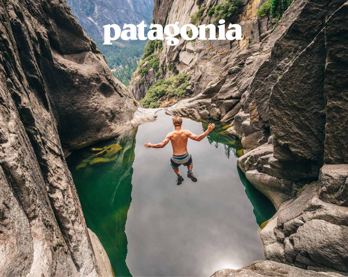Patagonia. A person jumps off a rocky ledge into a pool of water.