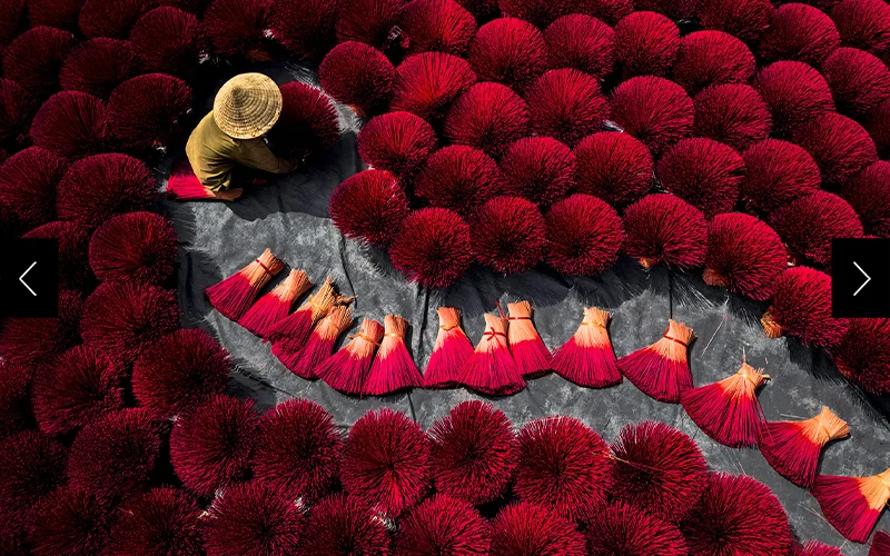 In Hanoi, a woman dries incense for people to pay respect to their ancestors.