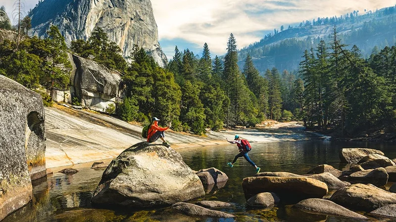Image description: Hikers explore Yosemite's Emerald Pool.