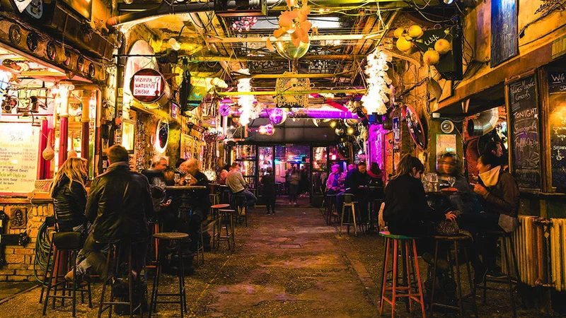 Image description: People drinking at Szimpla bar, in Budapest.