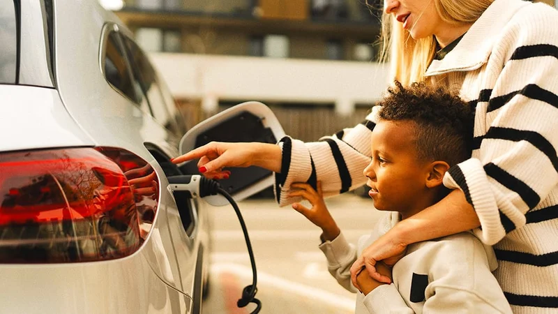 Image description: Mother and son at EV charging station.