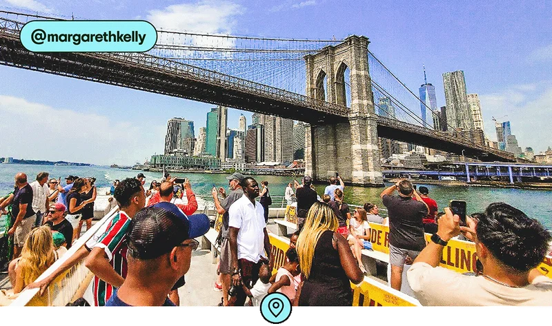 Image description: A view of the Brooklyn Bridge and lower Manhattan from the top level of a ferry, photo taken by @margarethkelly