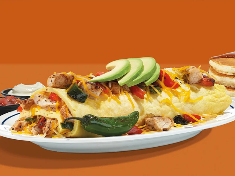 A plated Spicy Poblano Omelette topped with avocado slices