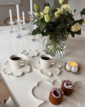 Unikko salad plates scattered on a table with some dessert on top. Unikko salad plates scattered on a table with some dessert on top.