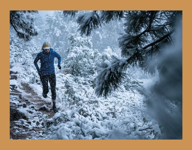 A person running on a trail in the snow.