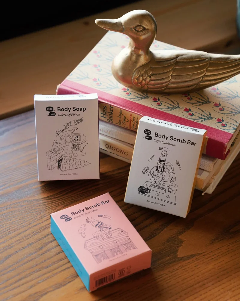 Three soap boxes are strewn in front of a stack of books with a brass duck on top