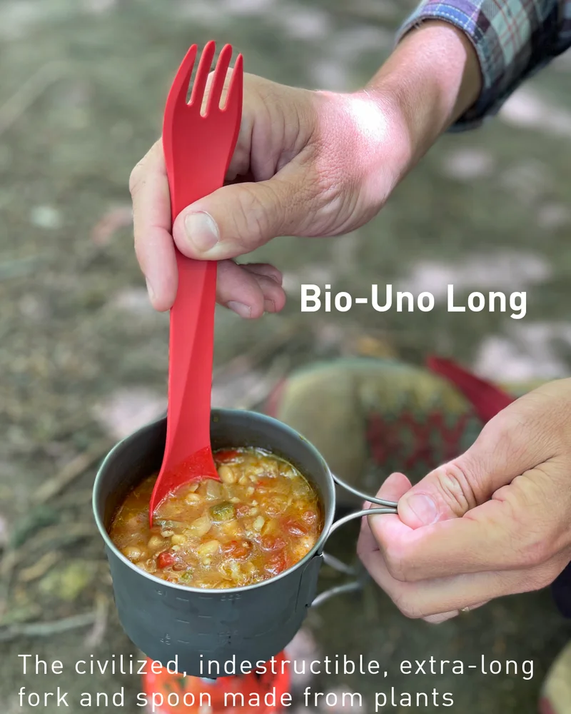 someone stirring soup with an uno long utensil