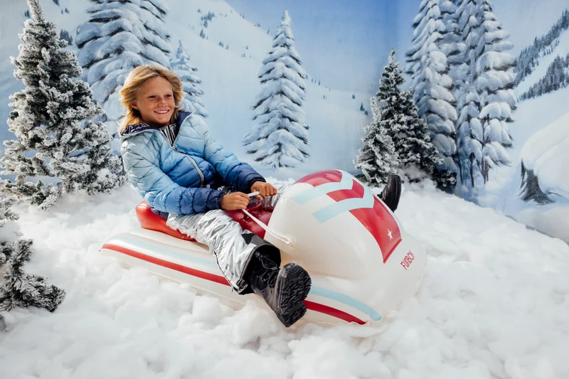 Child Riding the Red Racer Snow Sled (Image)