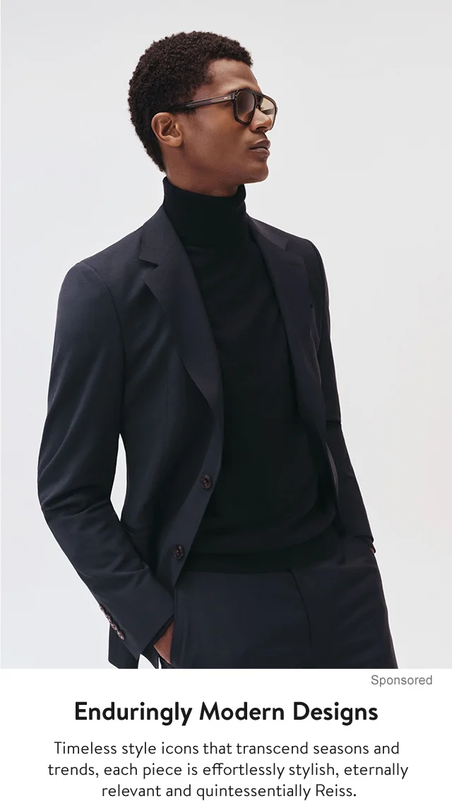 A man wearing a sport coat over a turtleneck.