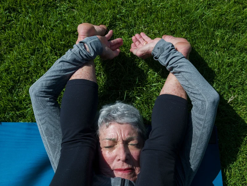An 83-year-old woman practices yoga. “The body of a 20-year-old is inherently different from the body of a 70-year-old. And somehow, something about exercise can cause a benefit in all these contexts,” says Saul Villeda, a neuroscientist at the University of California, San Francisco.