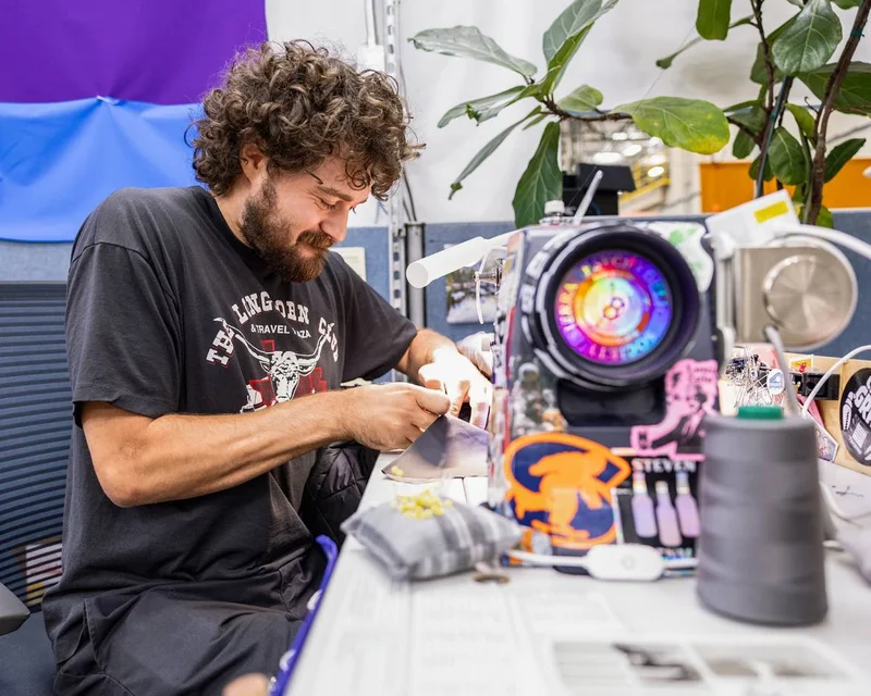 A person working at a sewing machine. Care in the repair.