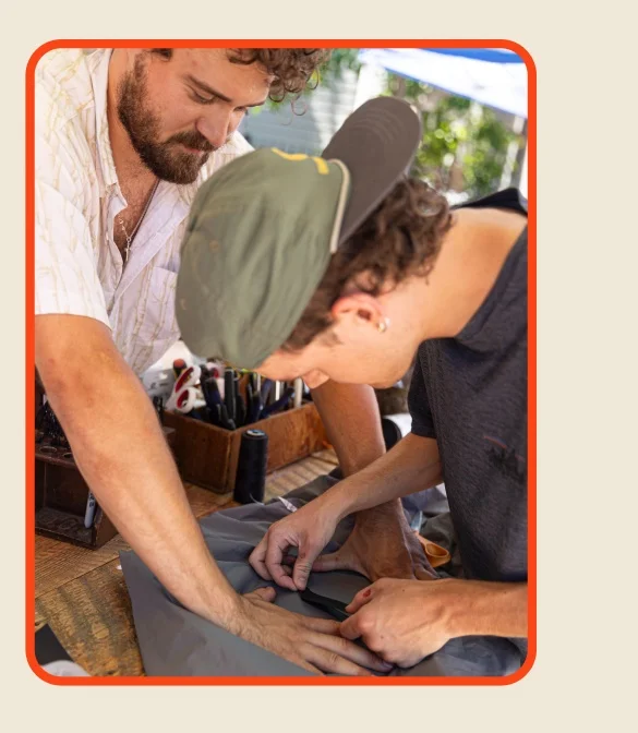 two people working together to fix a garment.