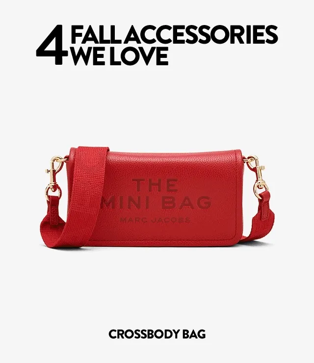 A red crossbody bag, blue scarf, gold hoop earrings and a newsboy cap.