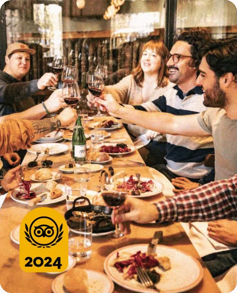 Image Description: Travelers toasting with wine glasses while on a food tour in Buenos Aires, Argentina