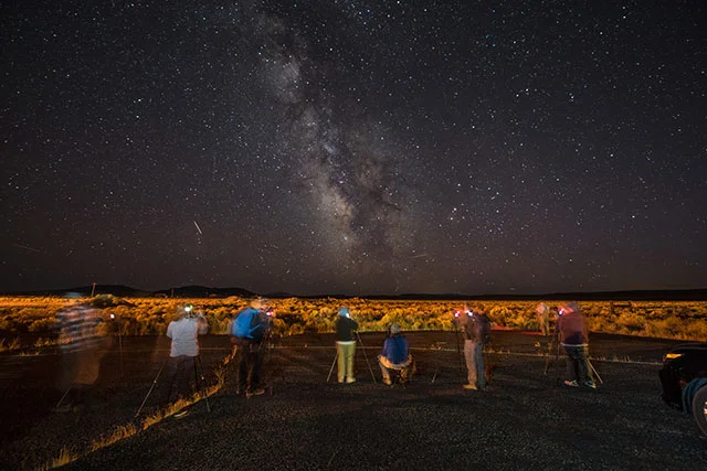 Visitors to DarkSky International look up at the night sky