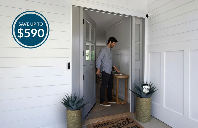 Up to $590 off. Person leaving their home through the front door where various Arlo security products are visible.