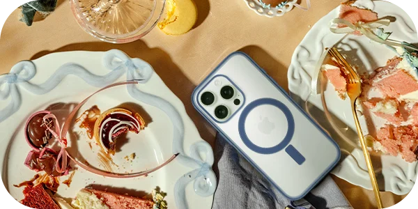iPhone with Defenders Series case on a table with sweet treats