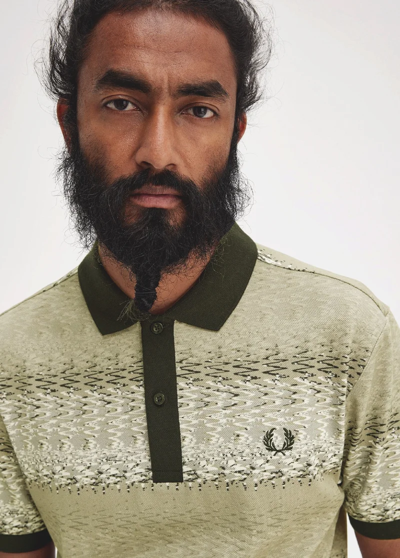 Male model wearing light green fred perry polo shirt