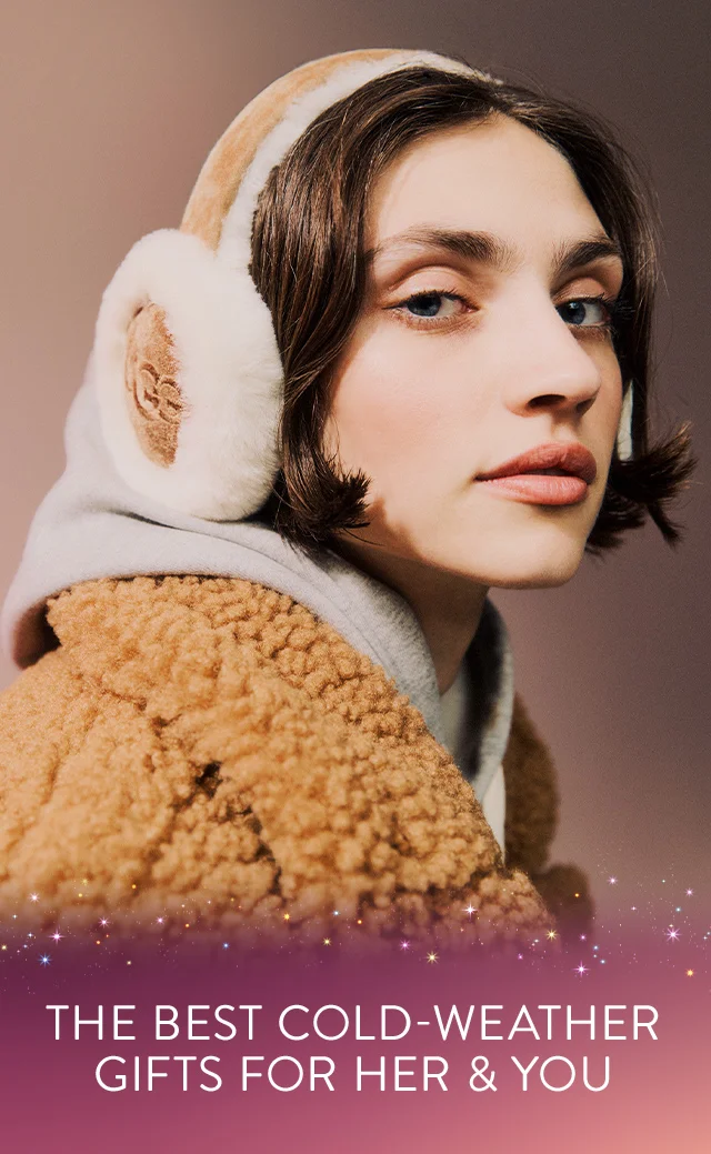 The best cold-weather gifts for her and you. Model wearing UGG earmuffs, a hoodie and a faux-fur jacket.