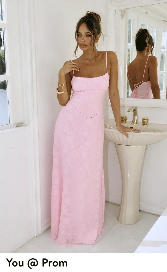 A woman wearing a pink maxi dress.