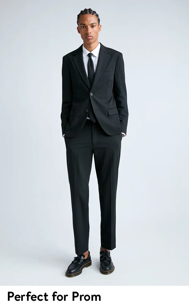 A young man wearing a sport coat and pants from Open Edit with Dr. Martens shoes.