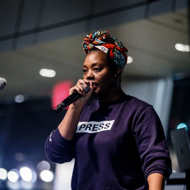 A woman speaking into a microphone