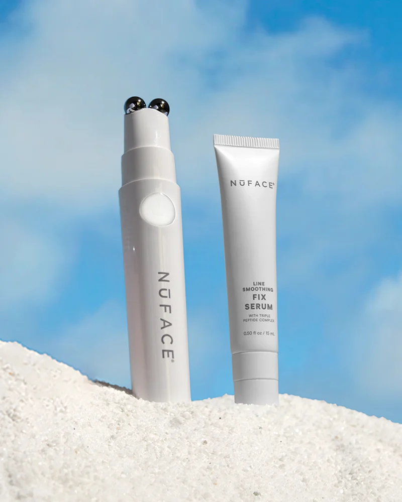 NuFACE FIX and NuFACE FIX Serum shown in the sand against a bright blue sky