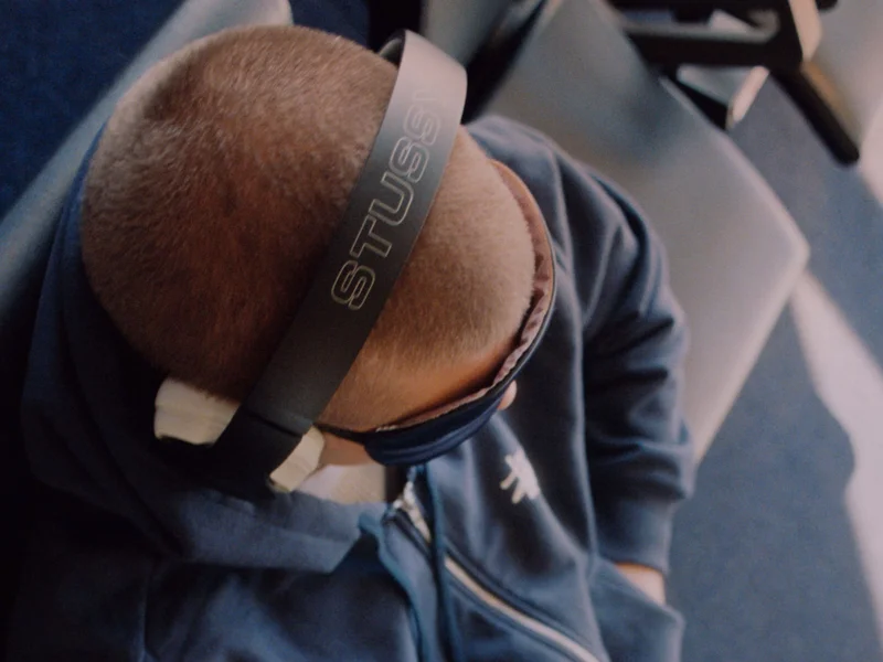 A person wearing the special edition Stüssy | Beats Studio Pro headphones.