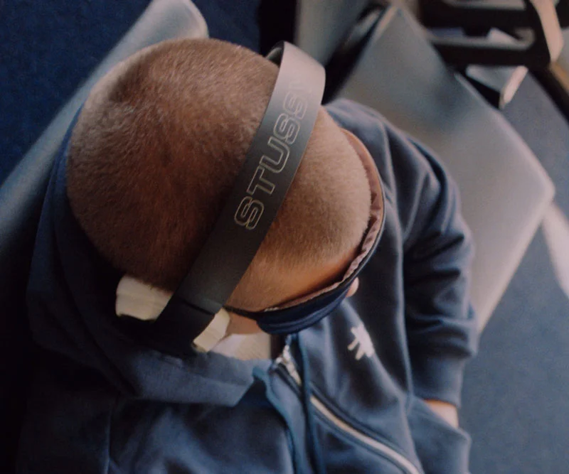 A person wearing the special edition Stüssy | Beats Studio Pro headphones.