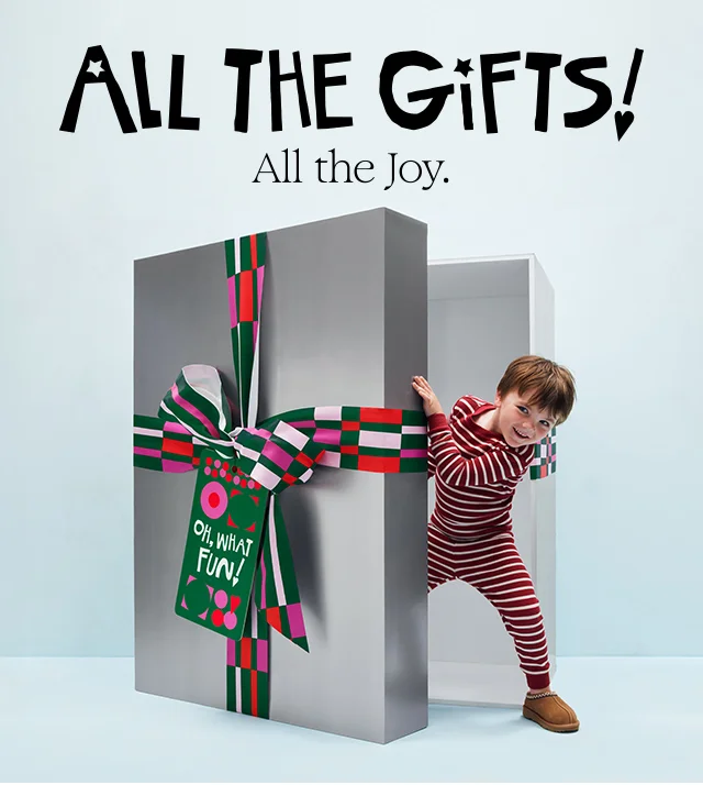 All the gifts, all the joy. A boy stepping out of a large gift box.