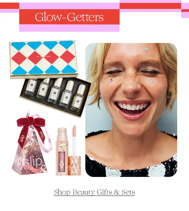 A perfume set, hair scrunchies and lip gloss next to a smiling woman.